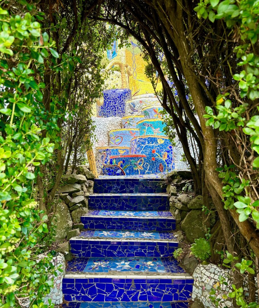 A blue and yellow staircase surrounded by trees.