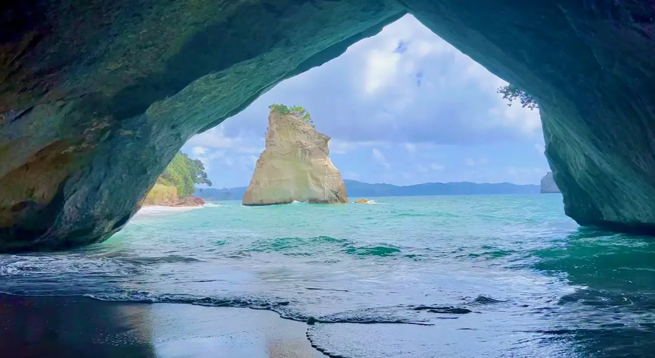 A view of the ocean from inside an arch.