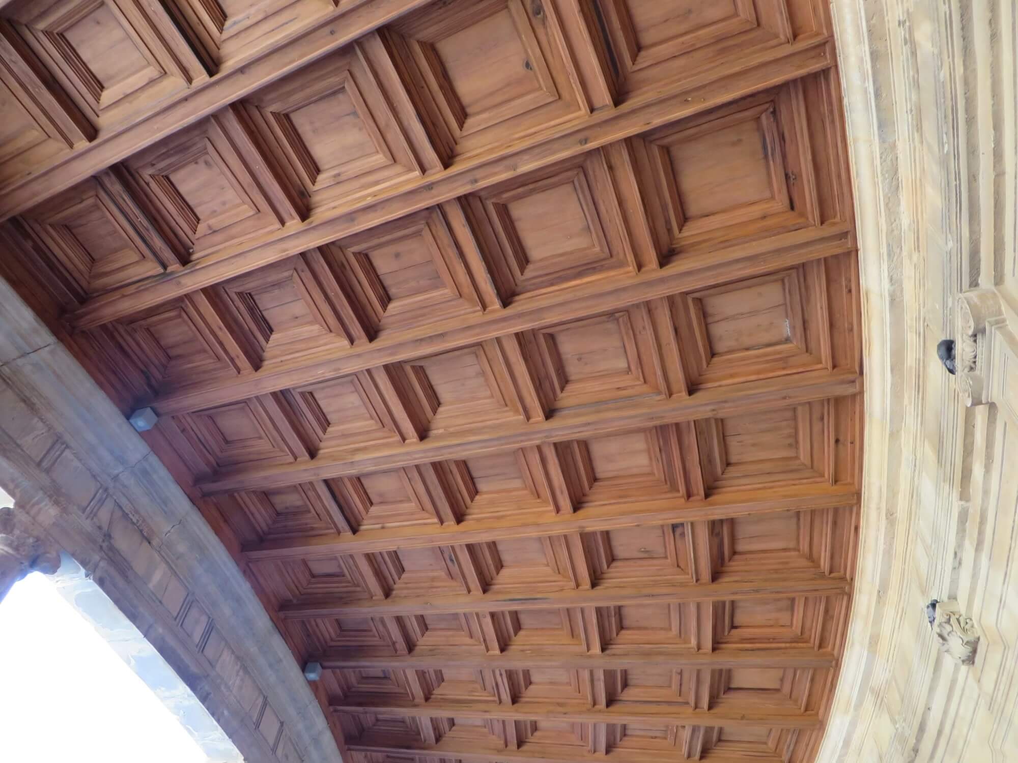 A ceiling with many wooden panels on it